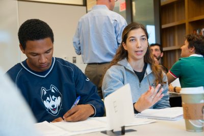 Professor, David Yalof observes his classroom during small group debates 