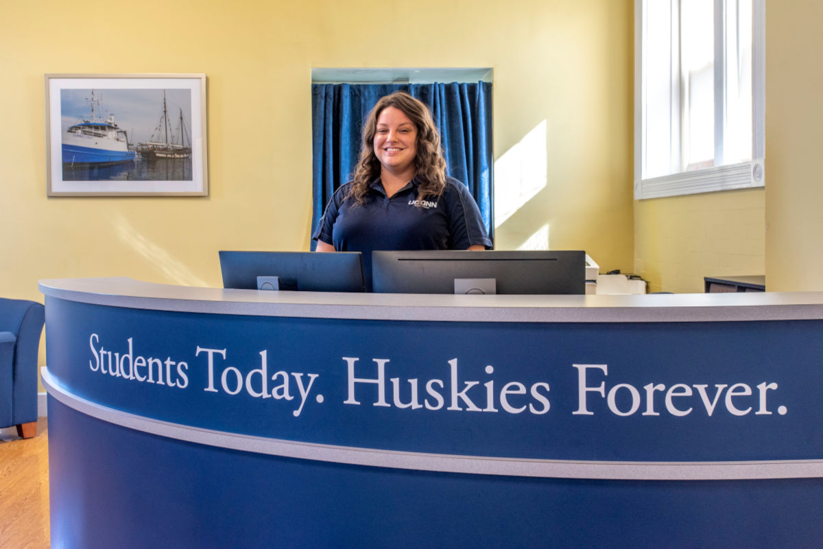 female standing behind a counter with