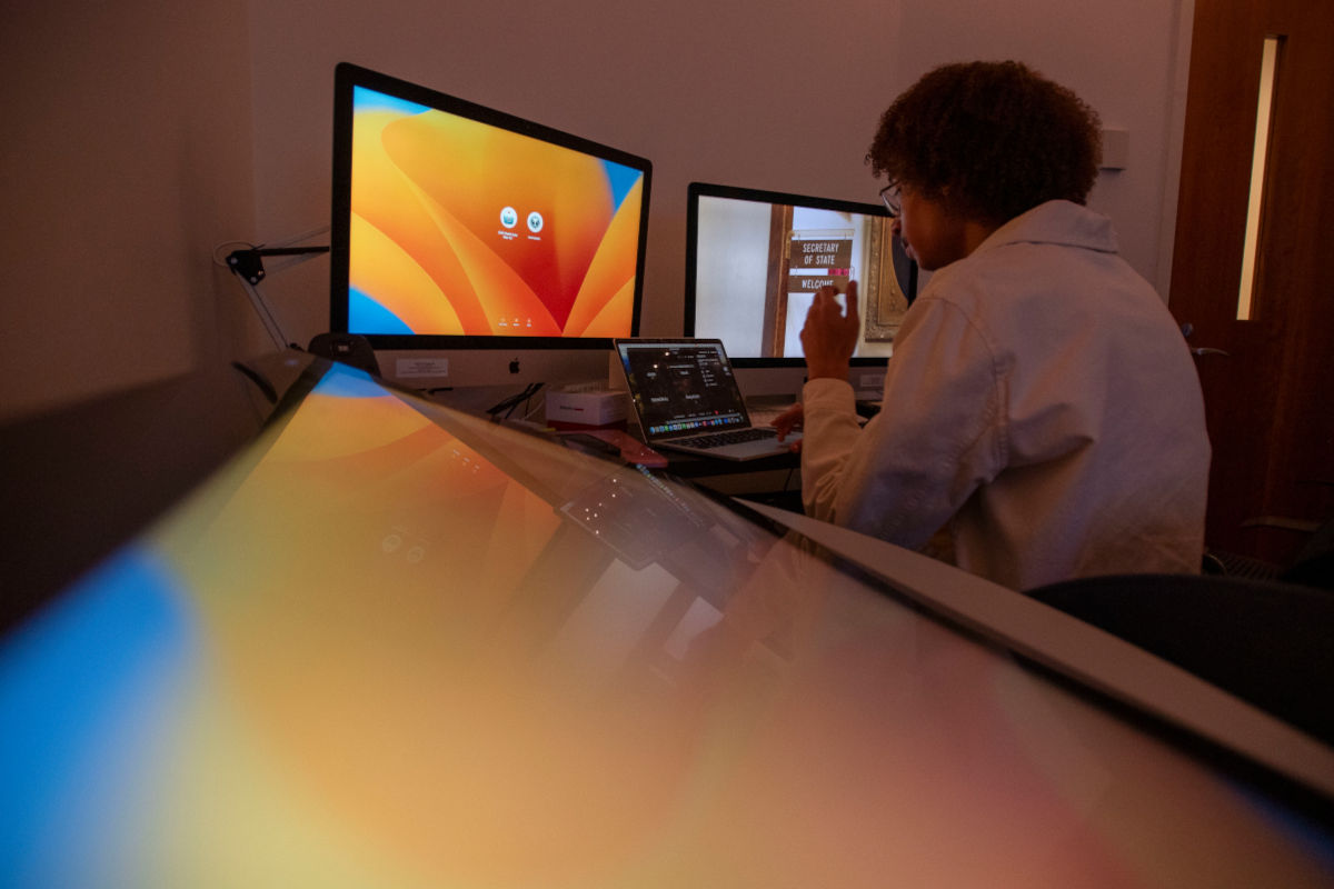 student applying for admission in front of computers